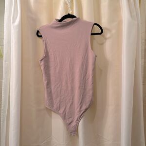 Express body contour bodysuit in rose mauvey color. Size L